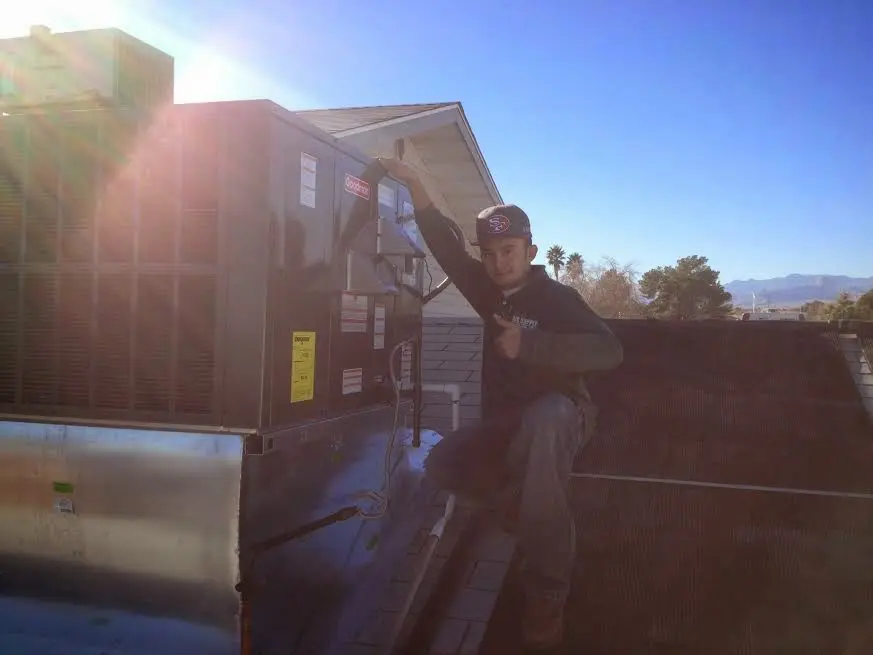 HVAC technician performing Boiler Repair on a rooftop unit in North Aurora